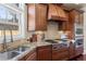 The kitchen features stainless steel appliances, granite countertops, stylish backsplash, and ample cabinet space at 2486 S Monroe St, Denver, CO 80210