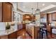 A modern kitchen with a central island, granite countertops, stainless steel appliances, and ample cabinet space at 2486 S Monroe St, Denver, CO 80210