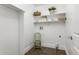 Laundry room featuring shelving, a utility sink and tile flooring at 2486 S Monroe St, Denver, CO 80210