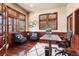 Cozy home office featuring wood trim, large windows, hardwood floors, and comfortable seating at 2486 S Monroe St, Denver, CO 80210