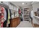 Spacious walk-in closet with custom shelving, drawers and hanging storage for organization at 2486 S Monroe St, Denver, CO 80210