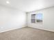 A bright bedroom features neutral carpeting, a large window and light gray walls at 763 N Tibet St, Aurora, CO 80018