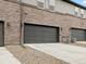 Attached garage doors provide convenient parking for multi-Gathering brick townhomes at 763 N Tibet St, Aurora, CO 80018