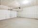 Spacious garage with concrete floor, a white door, and plenty of room for vehicles and storage at 763 N Tibet St, Aurora, CO 80018