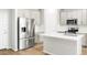 Modern kitchen with stainless steel appliances, white cabinets, and a center island at 763 N Tibet St, Aurora, CO 80018