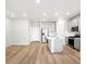 Open-concept kitchen with stainless steel appliances and center island at 763 N Tibet St, Aurora, CO 80018