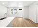 Bright living room featuring wood floors and a modern entryway door at 763 N Tibet St, Aurora, CO 80018