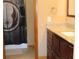 Bathroom with a granite countertop, custom cabinets, and a themed shower curtain at 155 Xenon St # 33, Denver, CO 80228