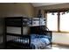 bedroom with a bunkbed, a window providing natural light and fun decor at 155 Xenon St # 33, Denver, CO 80228