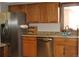 Well-lit kitchen features stainless steel appliances, granite countertops and wood cabinets at 155 Xenon St # 33, Denver, CO 80228