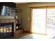 A cozy living room with a brick fireplace, sliding glass door, and outside views at 155 Xenon St # 33, Denver, CO 80228