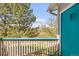 Relax on the balcony with views of trees and distant hills at 8405 Pebble Creek Way # 202, Highlands Ranch, CO 80126