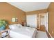 Cozy bedroom featuring ample natural light, a comfortable bed, and a charming view of the outdoors at 8405 Pebble Creek Way # 202, Highlands Ranch, CO 80126