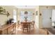 Bright dining area with natural light, classic wooden furniture, and a charming pendant light fixture, perfect for gatherings at 8405 Pebble Creek Way # 202, Highlands Ranch, CO 80126