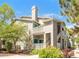 Attractive condo building featuring multiple units, exterior stairs, charming balconies, and well-maintained landscaping at 8405 Pebble Creek Way # 202, Highlands Ranch, CO 80126