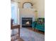 Close-up of a cozy fireplace with decorative tilework, a modern green sofa, and stylish decor in the living room at 8405 Pebble Creek Way # 202, Highlands Ranch, CO 80126