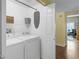 Clean and efficient laundry room with modern washer and dryer units and convenient shelving for storage at 8405 Pebble Creek Way # 202, Highlands Ranch, CO 80126
