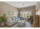 Comfortable living room bathed in natural light, showcasing cozy seating and pleasant views of the outdoors at 8405 Pebble Creek Way # 202, Highlands Ranch, CO 80126