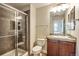 Modern bathroom features a tiled shower with glass door and updated fixtures at 10152 Inverness Main St, Englewood, CO 80112