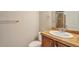 Cozy bathroom with wood vanity, tan tile counter, and walk-in shower with glass doors at 10152 Inverness Main St, Englewood, CO 80112