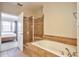 Well-lit bathroom featuring a separate shower and soaking tub with tile surround at 10152 Inverness Main St, Englewood, CO 80112