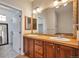 Bathroom vanity boasts double sinks, decorative mirrors, and ample cabinet space at 10152 Inverness Main St, Englewood, CO 80112