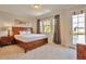 Comfortable bedroom features a large window, balcony access, and a wooden furniture set at 10152 Inverness Main St, Englewood, CO 80112