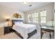 Cozy bedroom with large windows, a desk, and a dark furniture set at 10152 Inverness Main St, Englewood, CO 80112