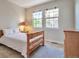 Bright bedroom with natural light and a wood frame bed and dresser at 10152 Inverness Main St, Englewood, CO 80112