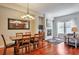 Open-concept dining area with hardwood floors, modern lighting, and a view of the cozy fireplace at 10152 Inverness Main St, Englewood, CO 80112