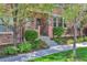 Inviting stone clad front entrance to a home with garden beds and a sidewalk at 10152 Inverness Main St, Englewood, CO 80112