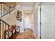 Inviting hallway with modern staircase, decorative art, and tile flooring at 10152 Inverness Main St, Englewood, CO 80112