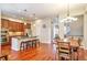 Spacious eat-in kitchen and dining area featuring wooden cabinets, granite countertops, and stainless steel appliances at 10152 Inverness Main St, Englewood, CO 80112