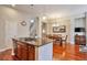 Bright kitchen open to dining room, with stainless steel appliances and center island at 10152 Inverness Main St, Englewood, CO 80112