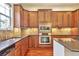 Well-equipped kitchen featuring custom cabinets, stainless steel appliances, and ample counter space at 10152 Inverness Main St, Englewood, CO 80112