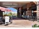 Outdoor seating area for a restaurant with sun umbrellas and happy hour signs at 10152 Inverness Main St, Englewood, CO 80112