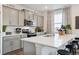 Modern kitchen with gray cabinets, white countertops, and stainless steel appliances at 43074 Merion Hills Ct, Elizabeth, CO 80107