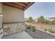 Back patio area with stone accent wall at 3573 S Lisbon Ct, Aurora, CO 80013