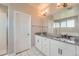 Bright bathroom features double sink vanity and a glass enclosed shower at 3573 S Lisbon Ct, Aurora, CO 80013