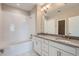 A well-lit bathroom with a double sink vanity, soaking tub, and tiled shower at 3573 S Lisbon Ct, Aurora, CO 80013