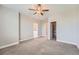 Spacious carpeted bedroom with ceiling fan, walk-in closet, and ensuite bathroom at 3573 S Lisbon Ct, Aurora, CO 80013