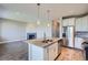 Open kitchen featuring a large island, granite counters, and modern appliances with a view to the living room at 3573 S Lisbon Ct, Aurora, CO 80013