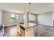 Granite kitchen island featuring a stainless steel sink, dishwasher and views of the backyard at 3573 S Lisbon Ct, Aurora, CO 80013