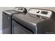 The laundry room features a modern washer and dryer at 3573 S Lisbon Ct, Aurora, CO 80013