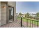 Relaxing wood patio with black metal railing overlooking a green lawn and neighborhood at 3573 S Lisbon Ct, Aurora, CO 80013