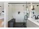 Bathroom walk-in shower features black accents, shower head and storage niche at 1920 S Niagara St, Denver, CO 80224