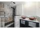 Bathroom featuring vessel sink, walk-in shower with stone tile, and overhead shower system at 2527 S Ouray Way, Aurora, CO 80013