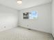 Empty bedroom with carpeted floors and large window at 2527 S Ouray Way, Aurora, CO 80013