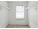 Walk-in closet with carpet, shelving, and a bright window with a shade at 2527 S Ouray Way, Aurora, CO 80013