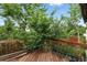 Wooden deck surrounded by lush greenery, offering a private outdoor space at 2527 S Ouray Way, Aurora, CO 80013